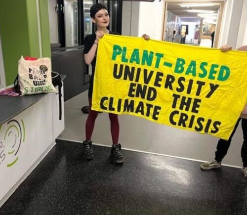 Stirling Students hold up a Plant-Based University banner