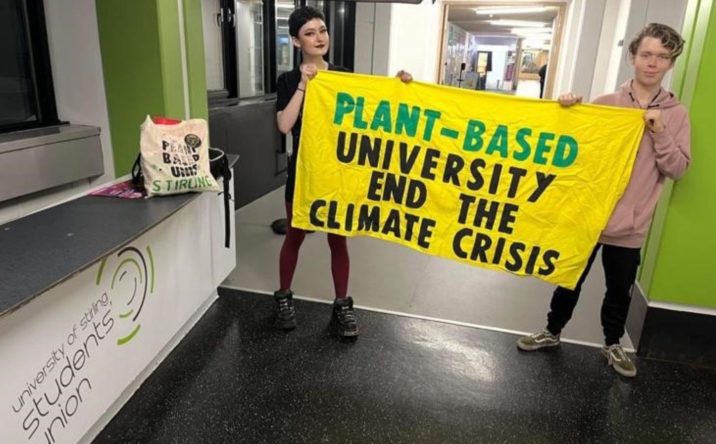 Stirling Students hold up a Plant-Based University banner