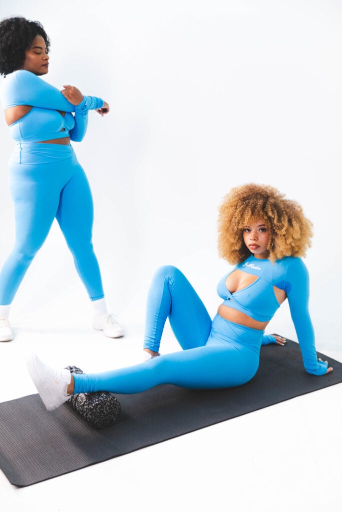 Two women wearing vegan Bamboo Athleisure Wear by JusRédor and stretching
