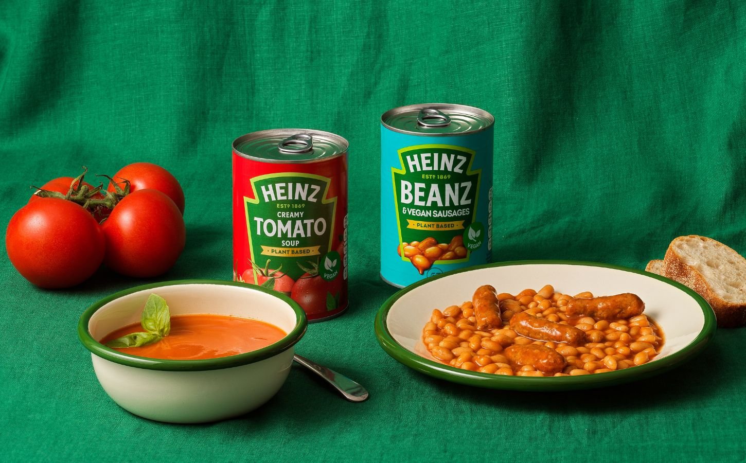 A can of Heinz vegan Cream Of Tomato soup besides a can of vegan sausages and beans