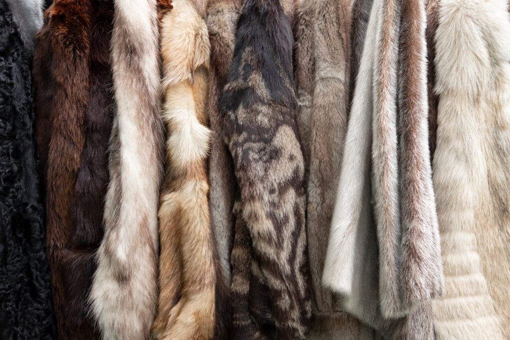 a selection of fur coats on a rack