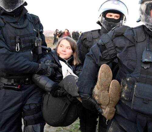 Vegan climate activist Greta Thunberg being carried away from a protest by the police
