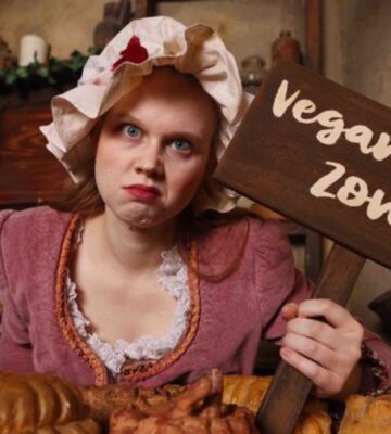 'Mrs Lovett' at London Dungeon holding up a "vegan free zone" sign