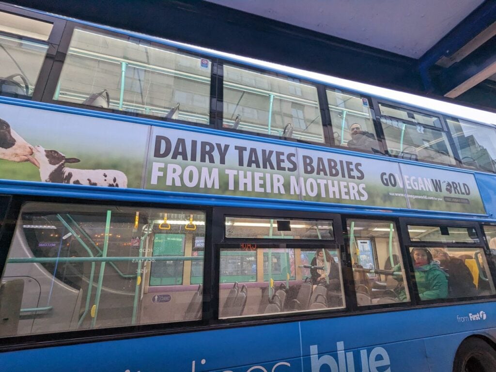 A Bristol Bus with a vegan advert on the side of it