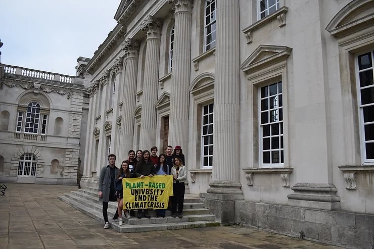 College students holding a pro-vegan banner at Cambridge University