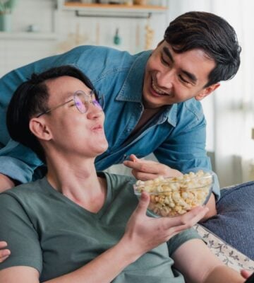 a young gen z couple eating popcorn together