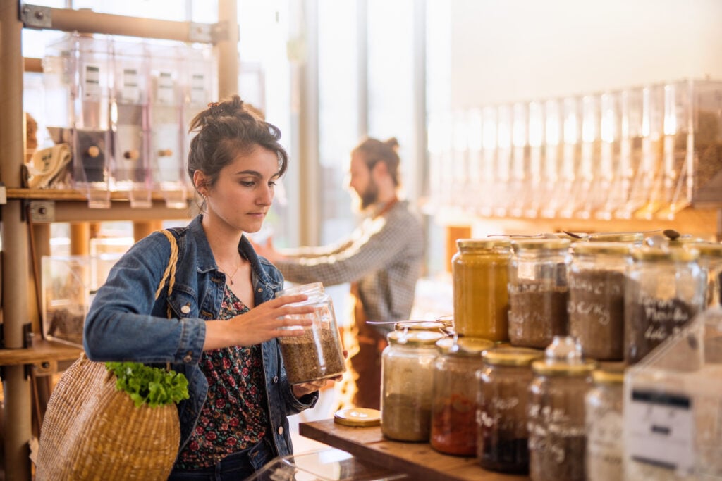 A woman shopping for vegan and vegetarian foods at a health store