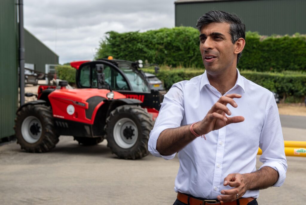 Rishi Sunak speaking at a farm in front of a tractor