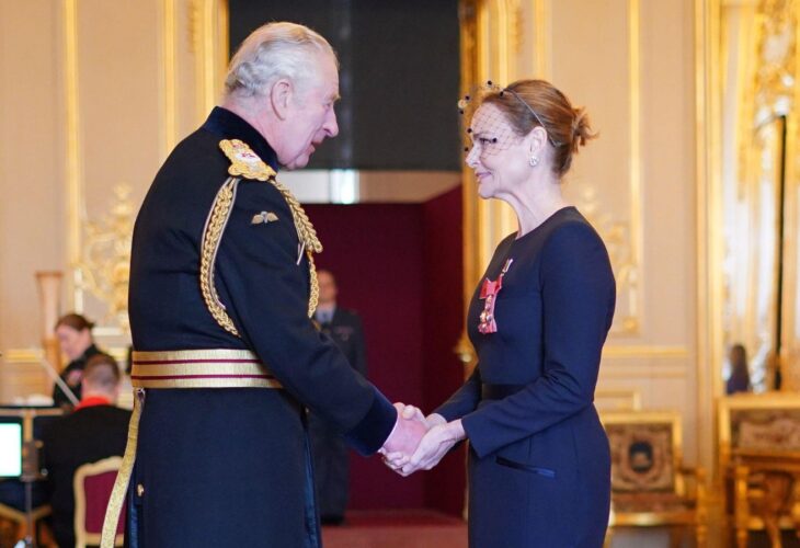 Vegetarian designer Stella McCartney shaking hands with King Charles after receiving her CBE