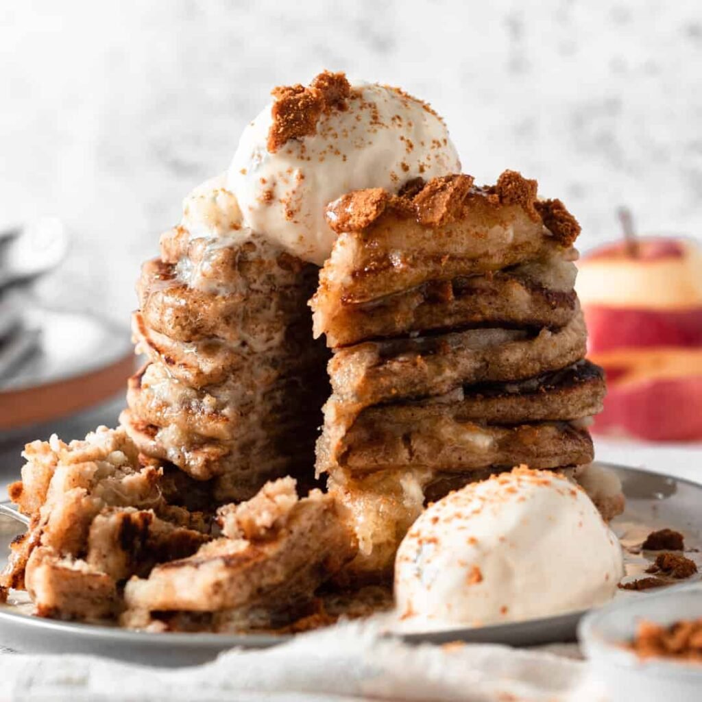 Vegan pancakes topped with apple pie ingredients and dairy-free ice cream