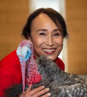 Vegan entrepreneur Miyoko Schinner, founder and former CEO of dairy-free cheese brand Miyoko's Creamery, pictured holding a turkey