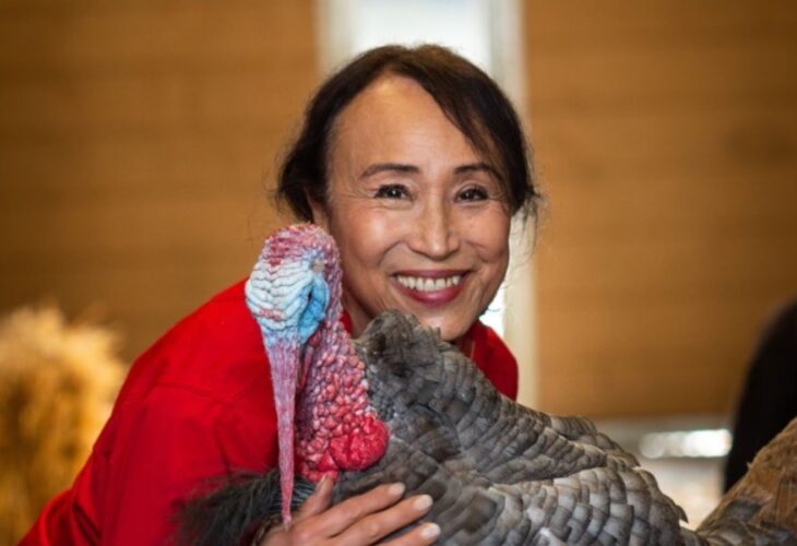 Vegan entrepreneur Miyoko Schinner, founder and former CEO of dairy-free cheese brand Miyoko's Creamery, pictured holding a turkey
