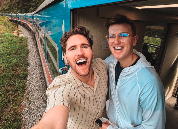 Vegan travelers Oscar and Dan on a train in Sri Lanka