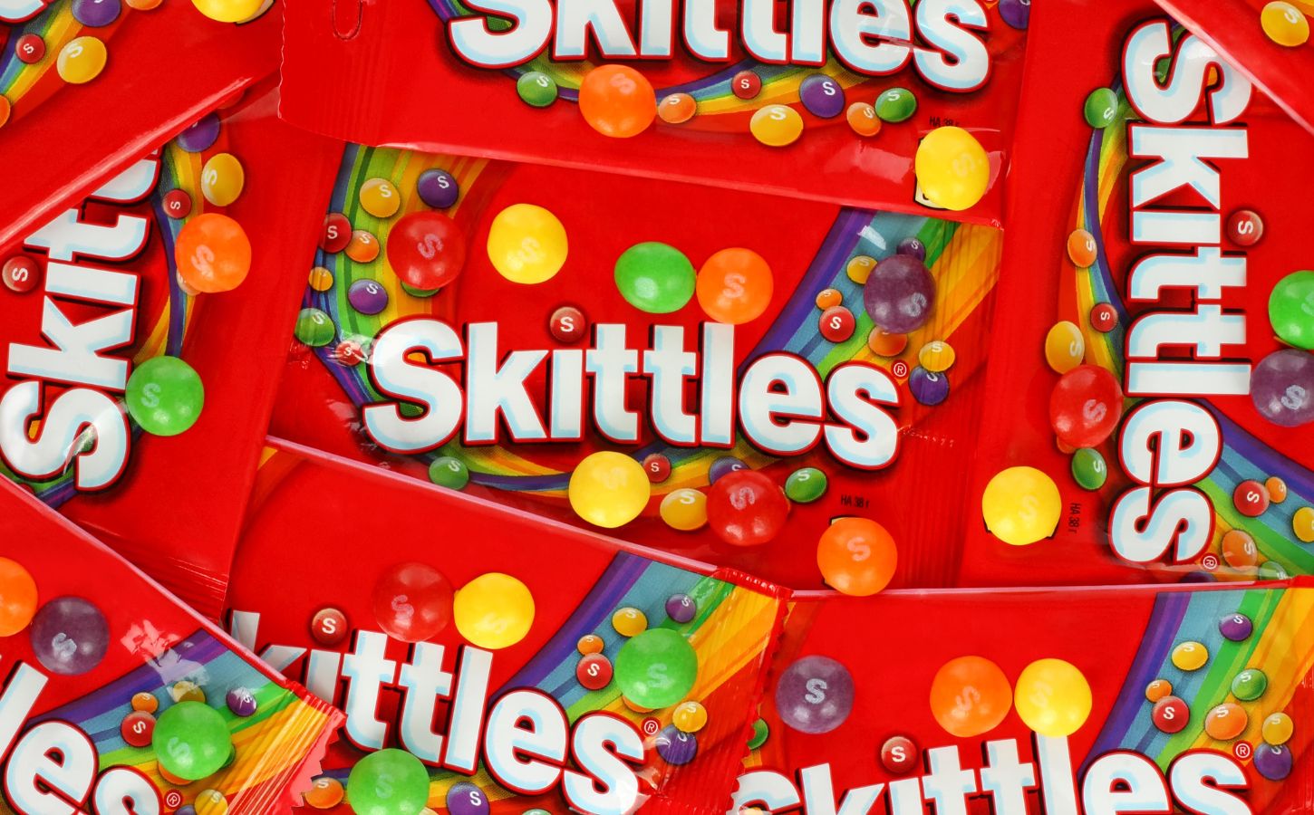A close up shot of packets of vegan sweets, made by candy brand Skittles