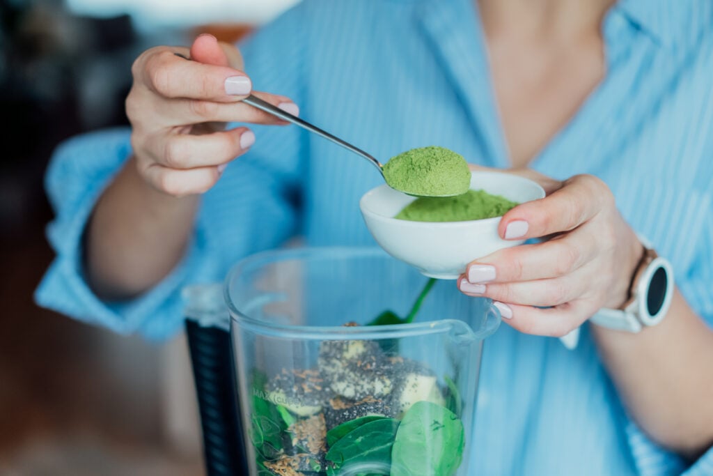 A person making a plant-based and vegan high protein smoothie