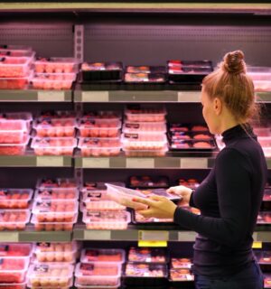 A woman shopping for raw meat in a supermarket
