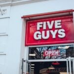 The exterior of a Five Guys fast-food restaurant in the UK