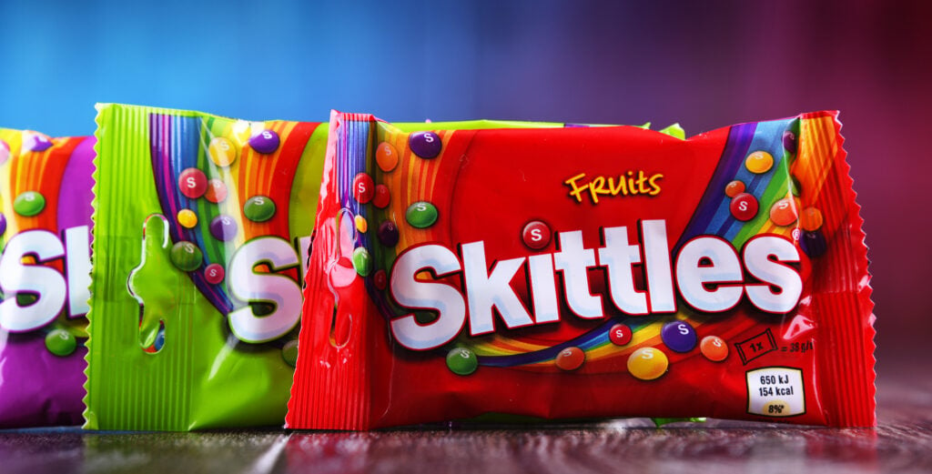 Three packs of vegan sweets, made by candy brand Skittles