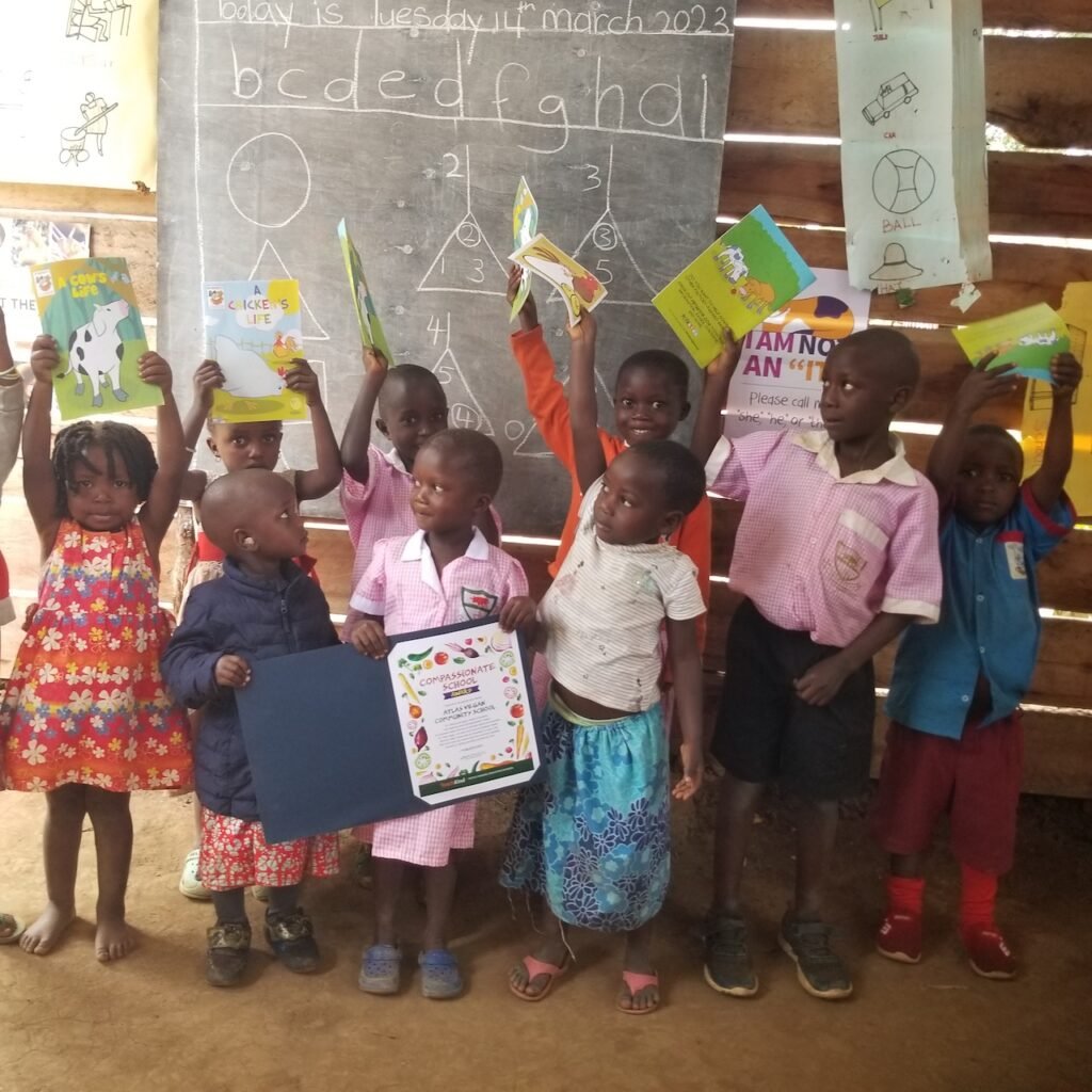 An Atlas Community School class holding the books they have been sent as part of the Compassionate School Award from TeachKind