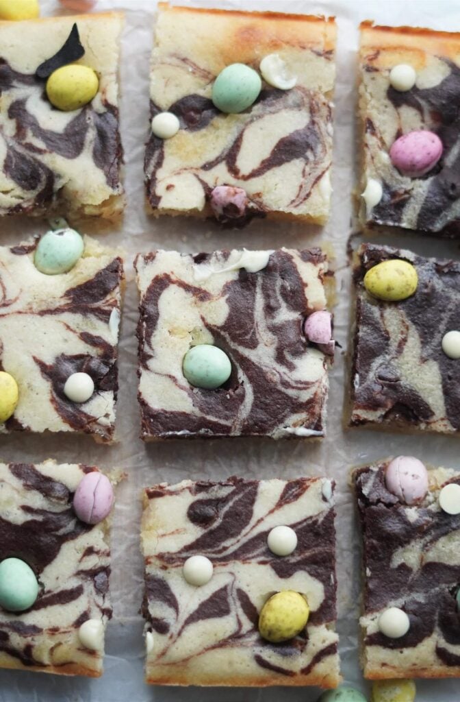 Freshly baked vegan dairy-free Easter blondies topped with colourful mini eggs