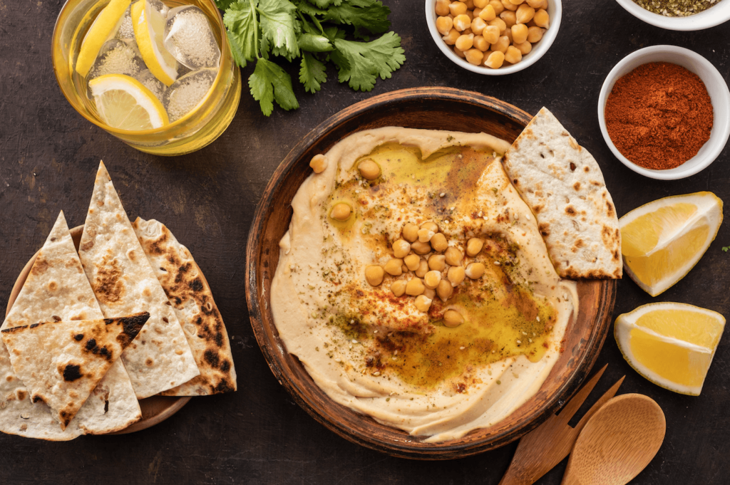 A vegan snack idea for students: hummus with chickpeas, paprika, olive oil and spices, eaten with pita