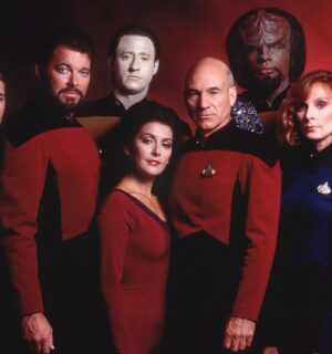 The cast of Star Trek Next Generation, said to contain vegan messaging, stood in front of a red background