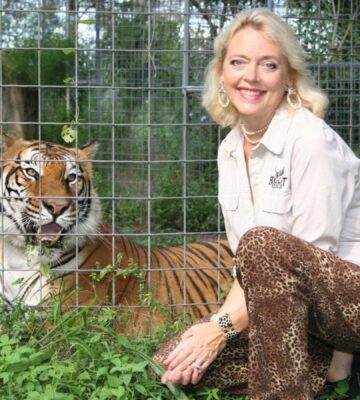 Carole Baskin in the 1990s crouched beside a tiger she has rescued