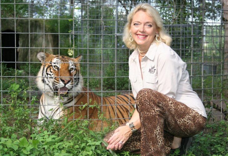 Carole Baskin in the 1990s crouched beside a tiger she has rescued
