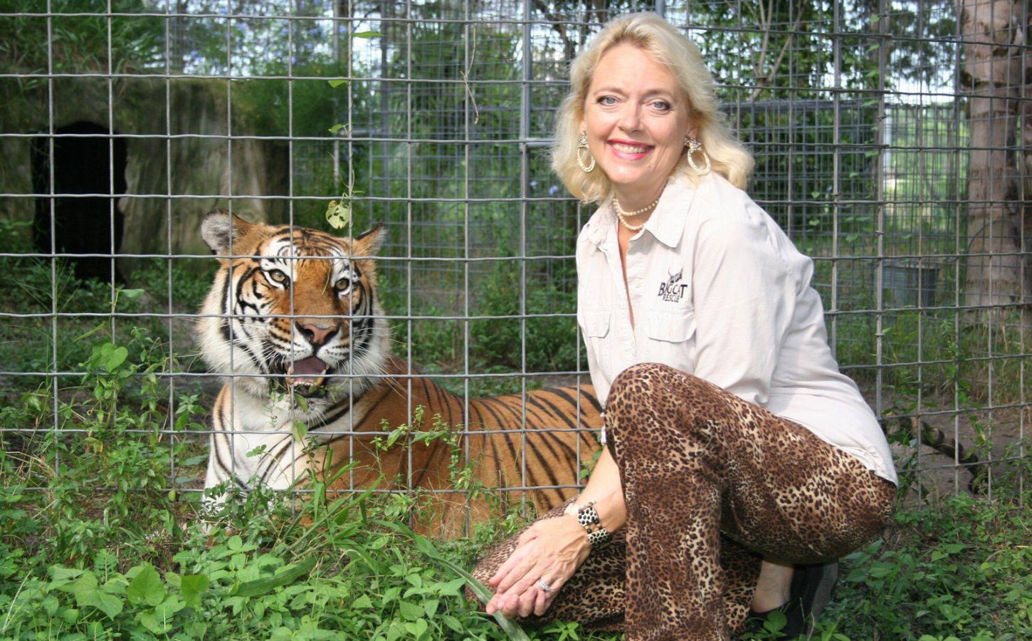 Carole Baskin in the 1990s crouched beside a tiger she has rescued