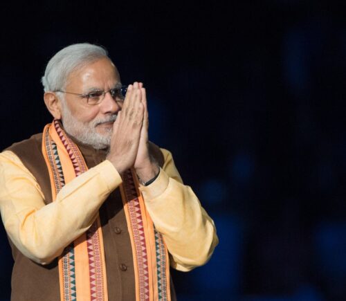 India's vegetarian prime Minister Narendra Modi demonstrating praying hands at an event