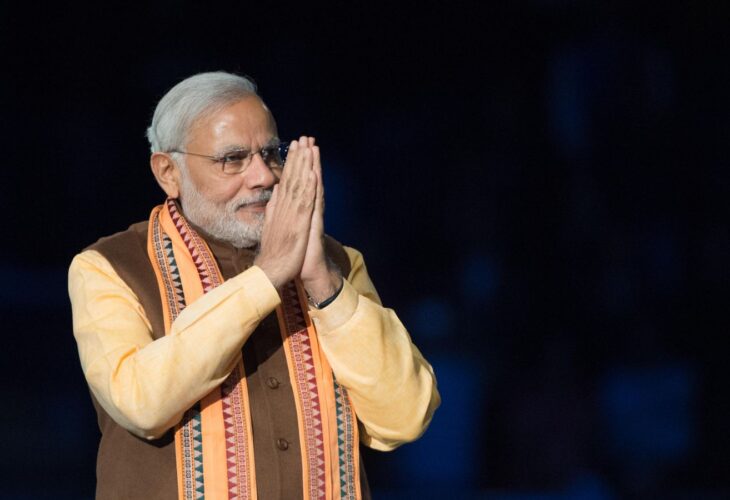 India's vegetarian prime Minister Narendra Modi demonstrating praying hands at an event