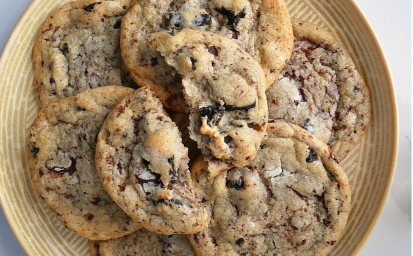 A stack of vegan cookies and cream-flavored biscuits on a plate