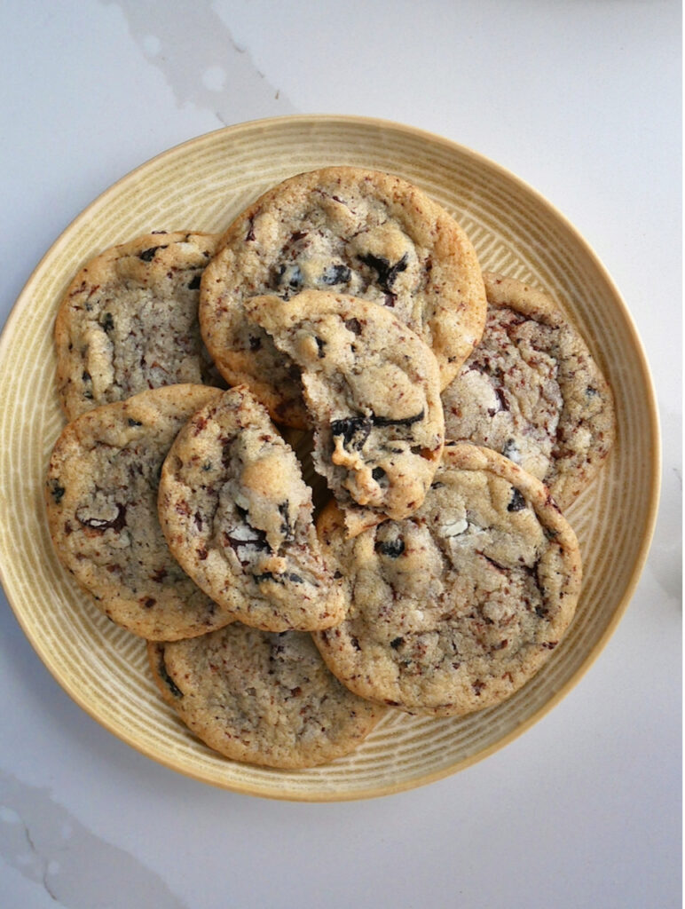 A plate of cookies and cream flavoured vegan cookies on a white countertop