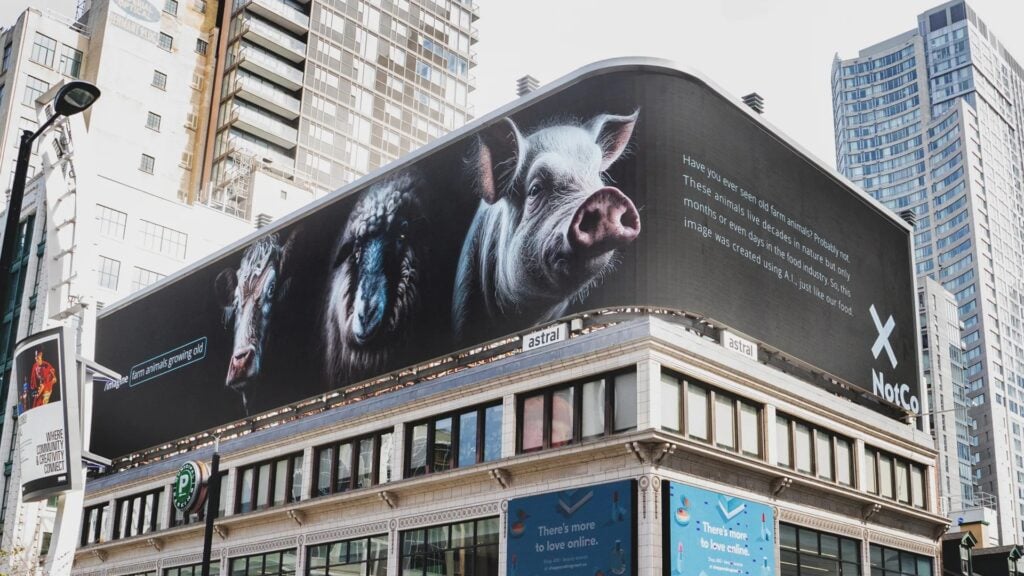 A NotCo billboard depicting three AI-aged farm animals and educational text about their natural lifespans