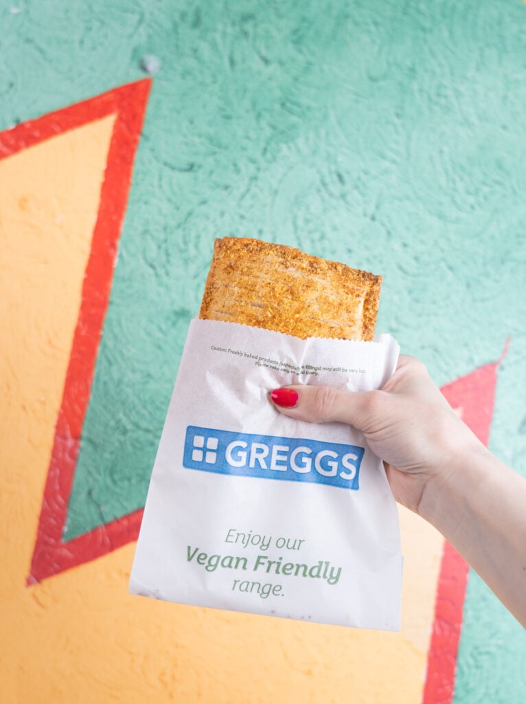 A person holding up a Greggs vegan chicken bake