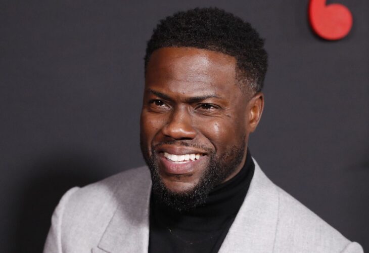 Kevin Hart in a grey suit, smiling