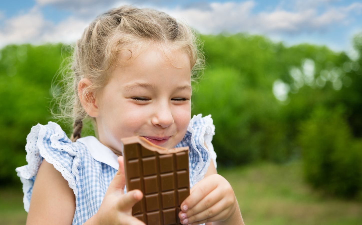 A young girl eating vegan chocolate