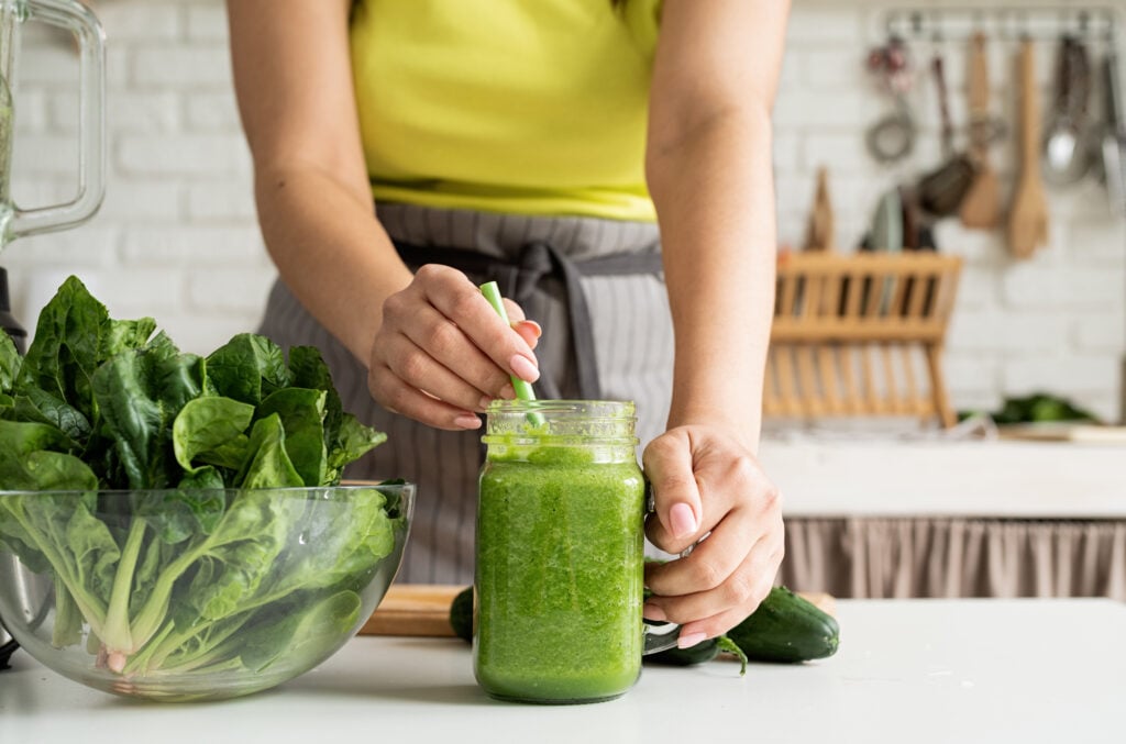 A person making a green smoothie