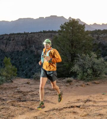 Vegan athlete and runner Austin Meyer running at sunset during the Zion 100km ultra-marathon