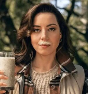 Actor Aubrey Plaza in a new satirical anti-vegan advert funded by the dairy industry, holding a glass of 'wood milk' with a milk mustache