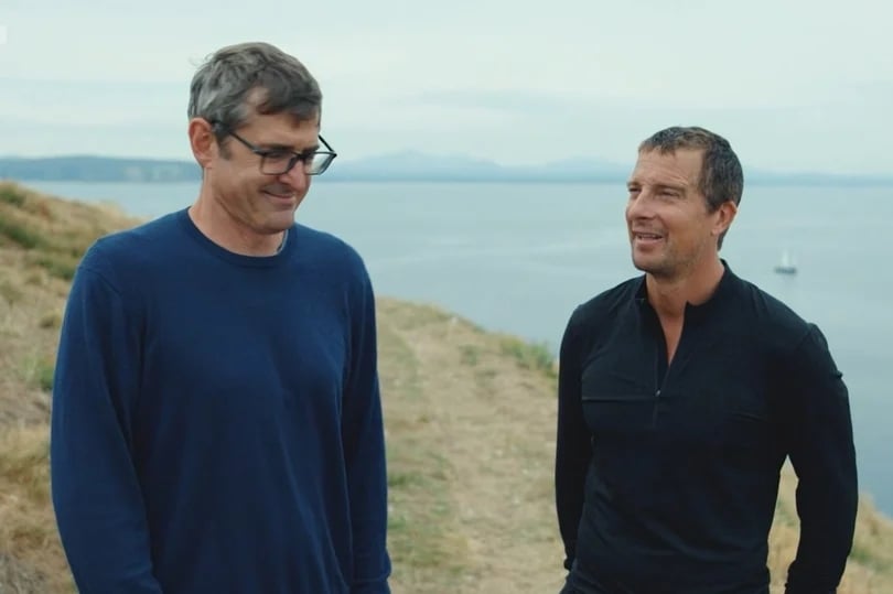 Former 'vegan' Bear Grylls and Louis Theroux standing on a cliff by the sea