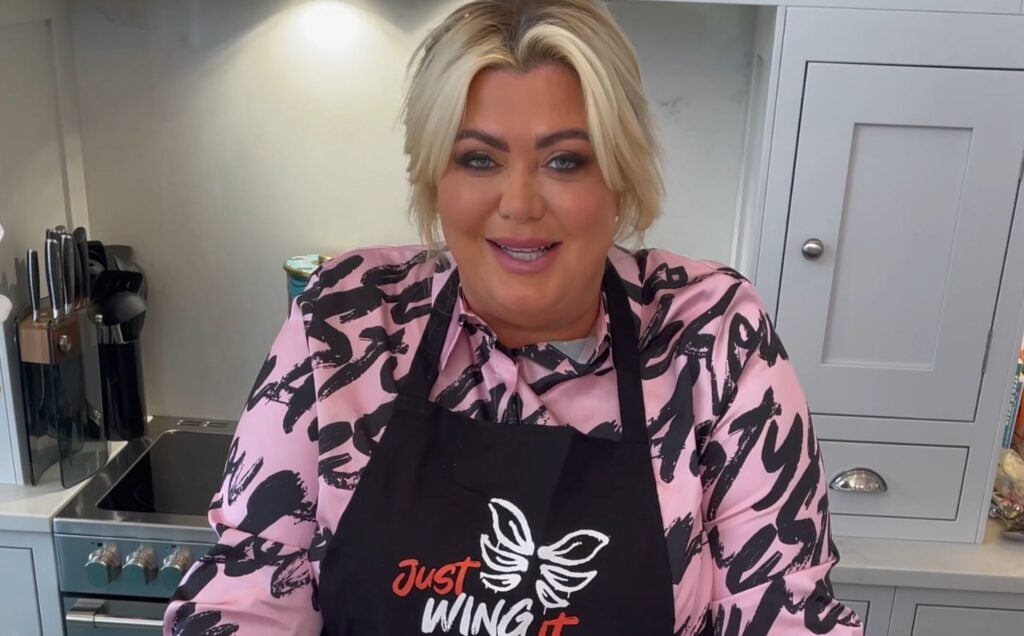 Vegetarian celebrity Gemma Collins wearing a VFC apron in a kitchen