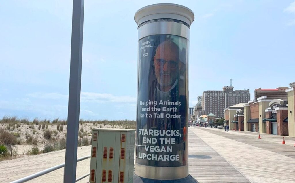 Vegan actor James Cromwell in an ad for PETA that urges Starbucks to ditch its surcharge on vegan milk. Situated on the Atlantic City Boardwalk