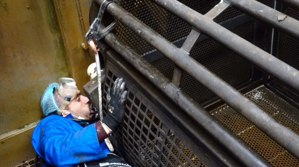 Joey Carbstrong installing hidden cameras in a pig gas chamber in a UK slaughterhouse