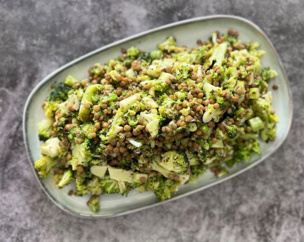Lentil and broccoli green vegan salad served on a rectangular platter