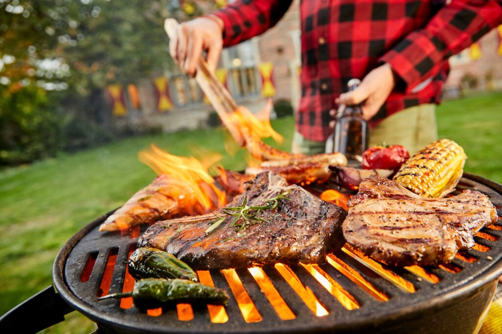 A man cooking meat on the BBQ