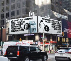 An Oatly billboard that challenges Big Dairy to reveal its environmental impact, in Times Square