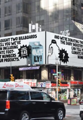 An Oatly billboard that challenges Big Dairy to reveal its environmental impact, in Times Square