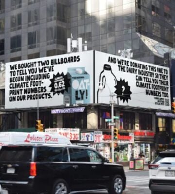 An Oatly billboard that challenges Big Dairy to reveal its environmental impact, in Times Square