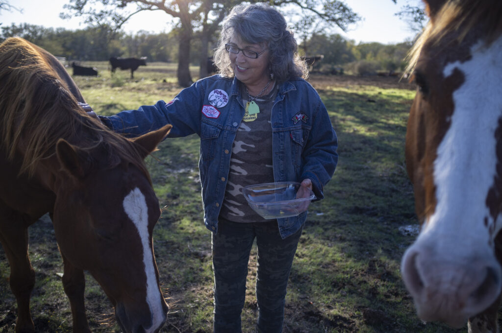 Renee King-Sonnen with horses at Rowdy Girl vegan animal rescue sanctuary in Texas